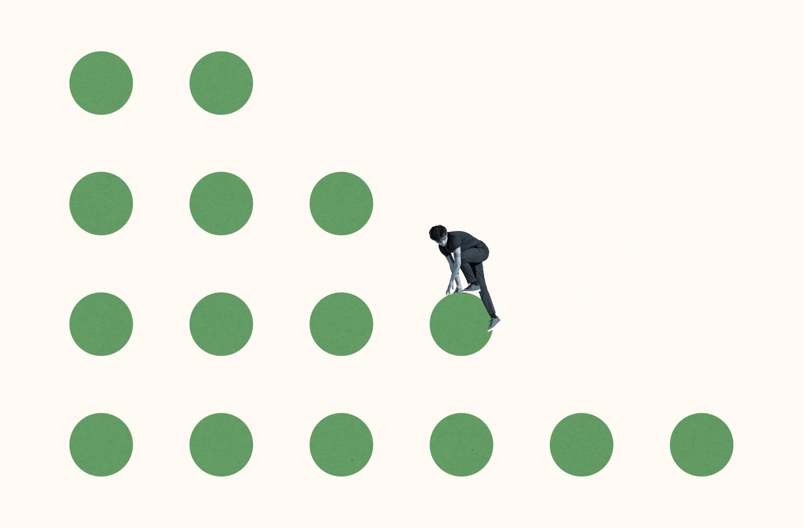 A person in a suit bends down to touch a green dot, surrounded by several green dots arranged in a grid pattern on a plain background.