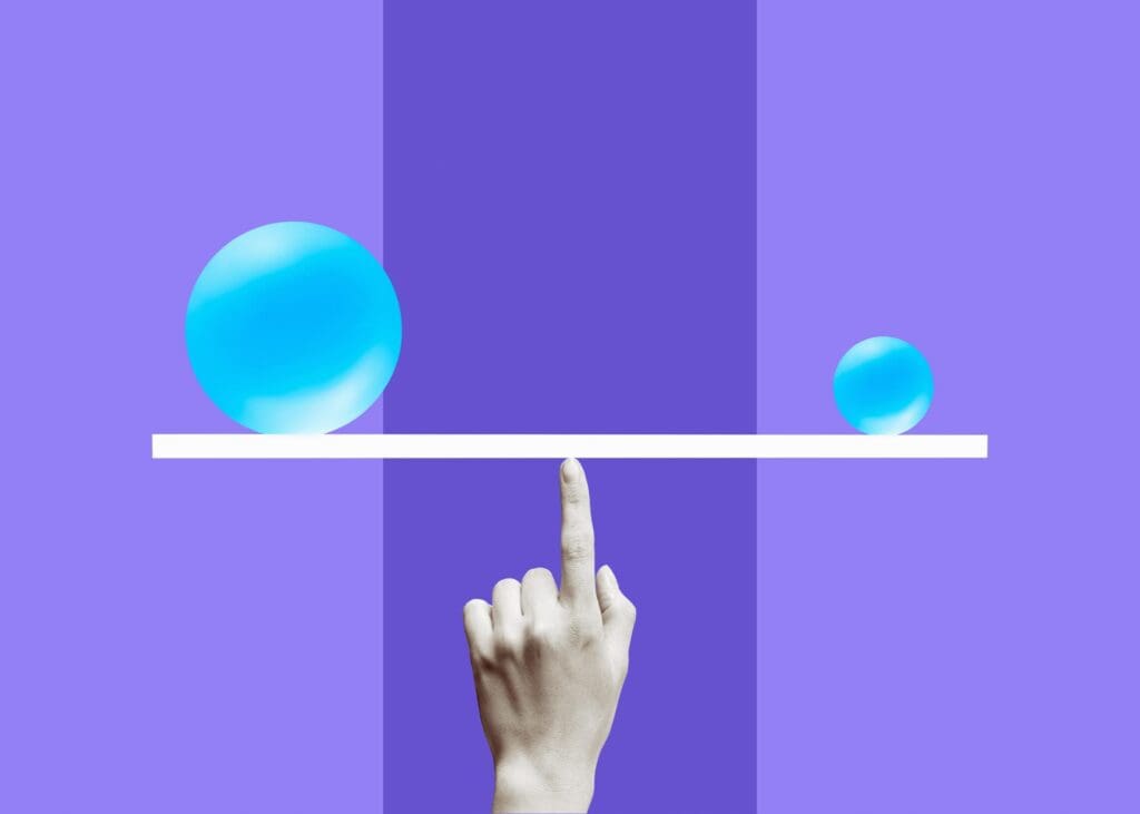 A hand points upward, balancing a seesaw with a large blue sphere on the left and a smaller blue sphere on the right, on a purple background.