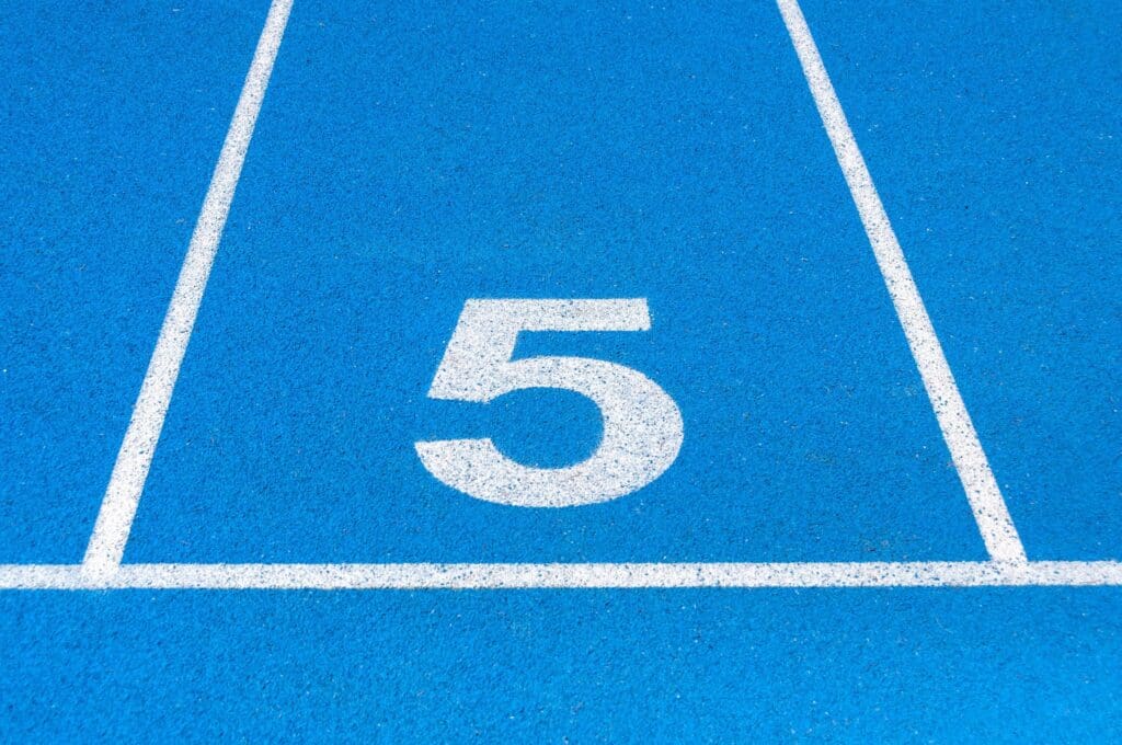 A blue running track lane with the number 5 marked in white.